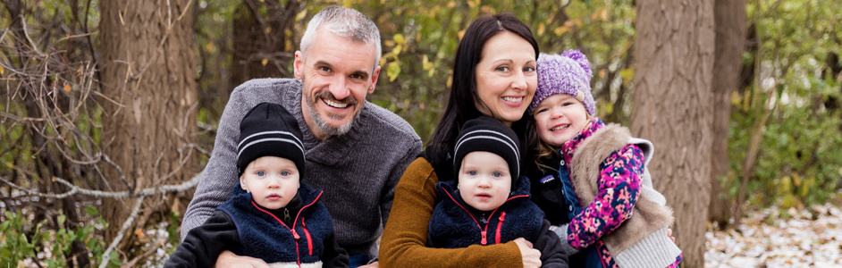 Parents Kathy and John with twin boys Cian and Rory out in the woods.