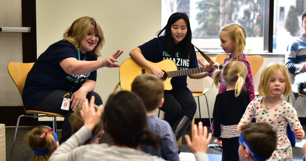 music therapists at an event teaching children