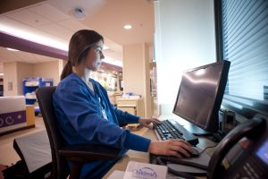 Medical assistant at computer
