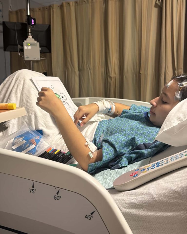 Genesis coloring in hospital bed.