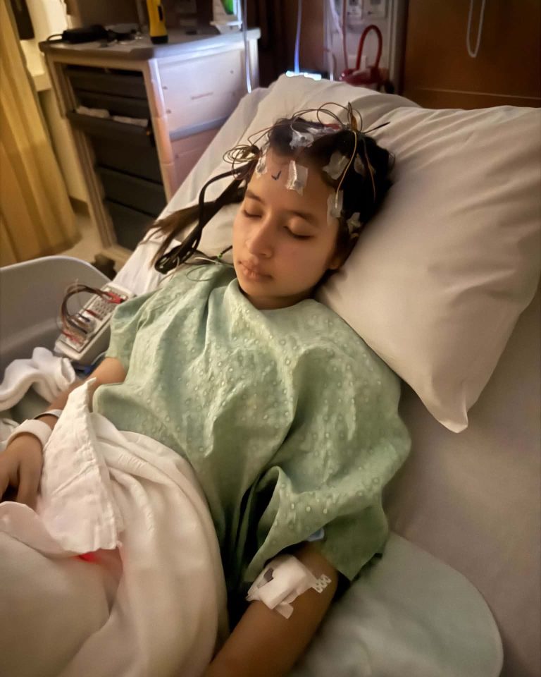 genesis laying on hospital bed