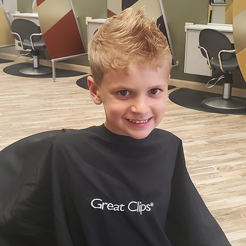Kid getting haircut during the Great Clips cut-a-thon