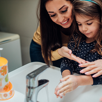 Mom and child washing their hands