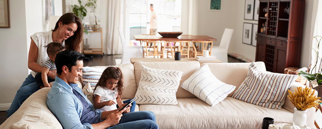 Family sitting on the couch in their home