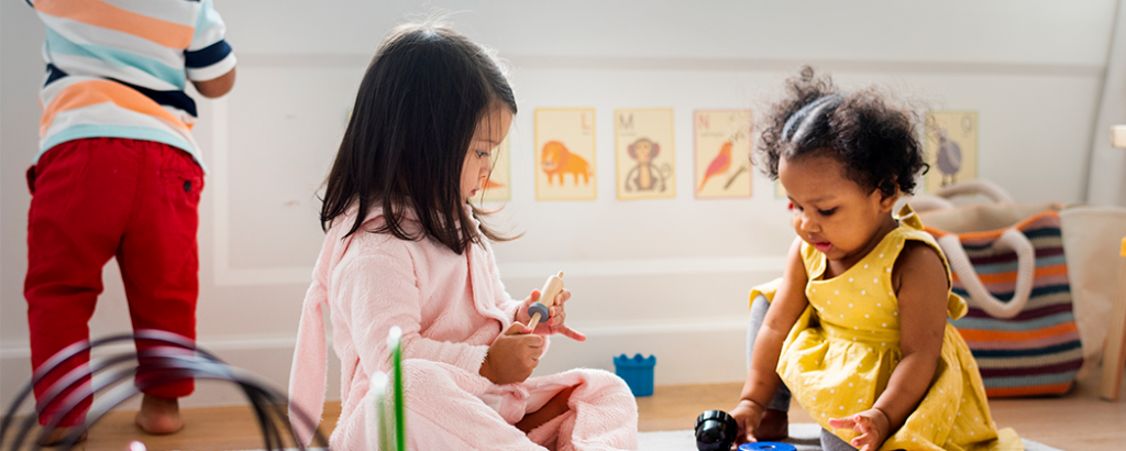 Children playing at home with toys