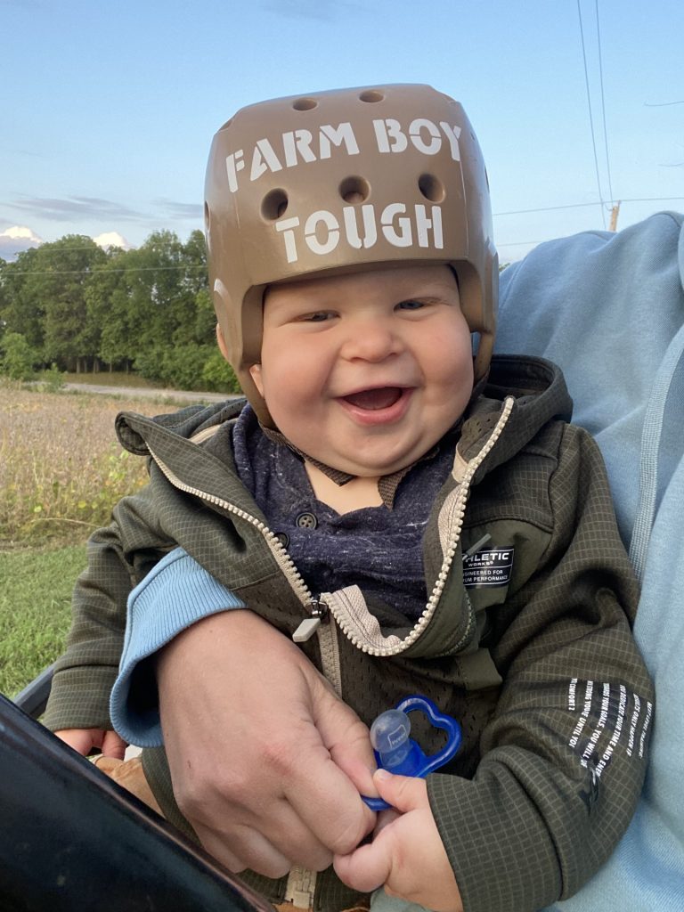 Henrik wearing a helmet with "farm boy tough" written on it.