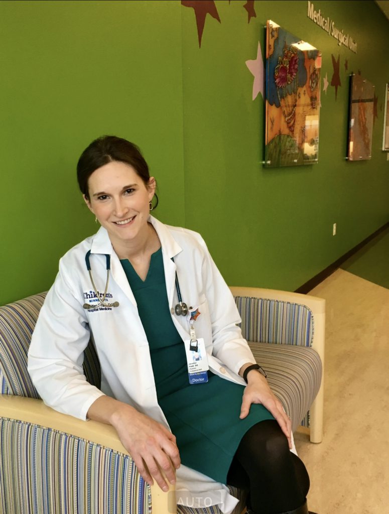 Dr. Jennifer Pratt smiles in her white coat