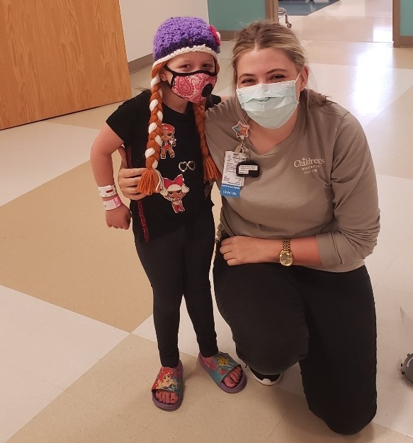 Harper with her child life specialist, Sam