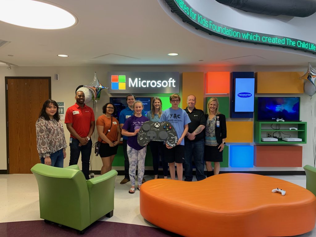 A group photo next to the Microsoft donation at the hospital
