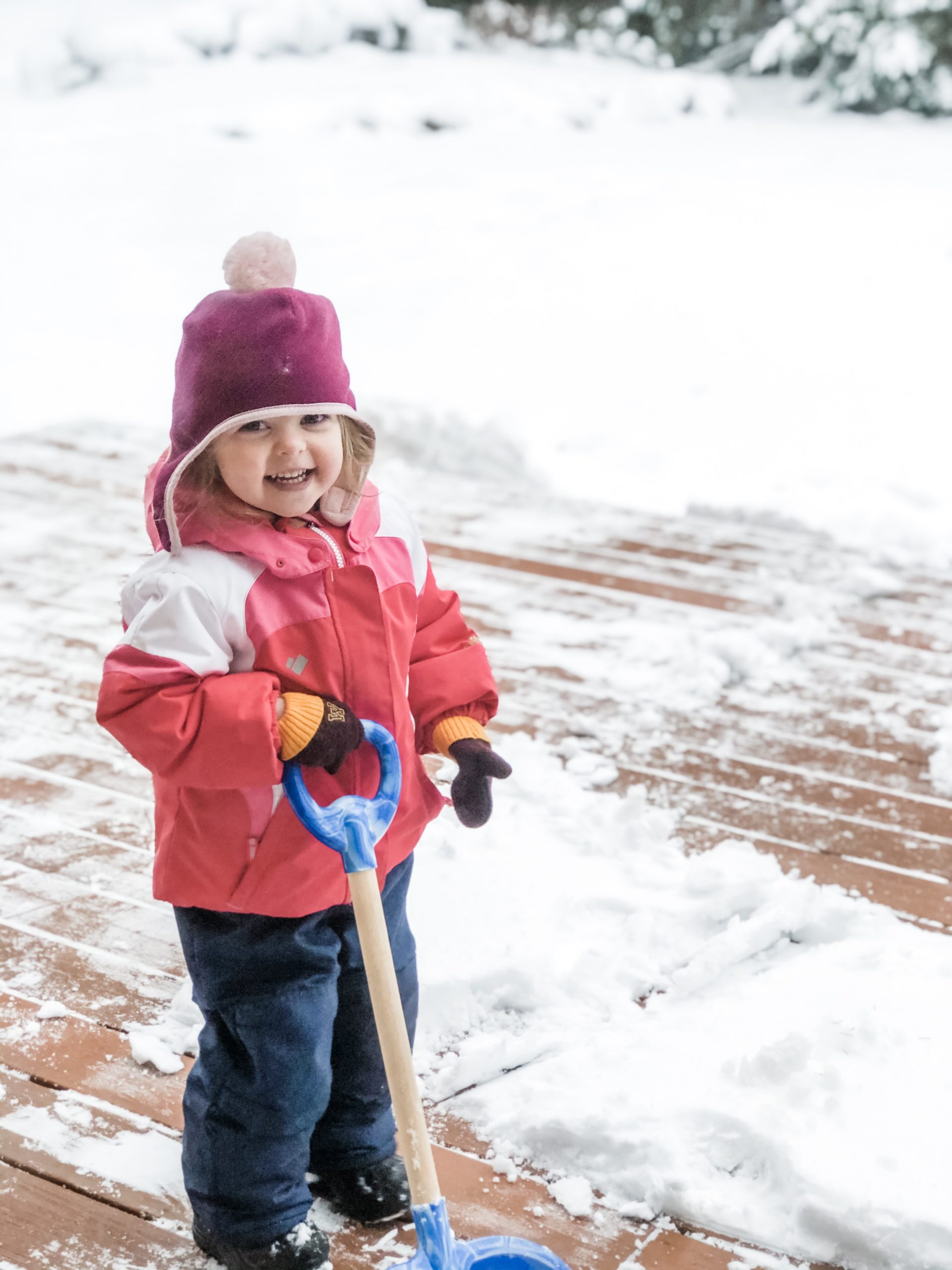 Mighty Margaret in winter clothes shoveling the snow from the driveway
