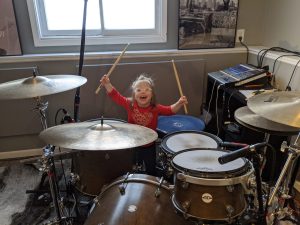 Alyssa playing the drums.