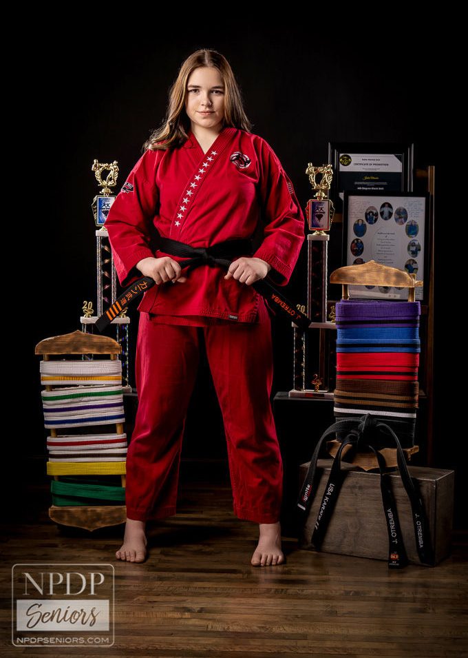 Jentai, age 19, poses for new karate photos in her black belt.