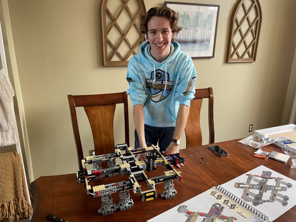 Henry, now 18 years old, at home with a Lego set
