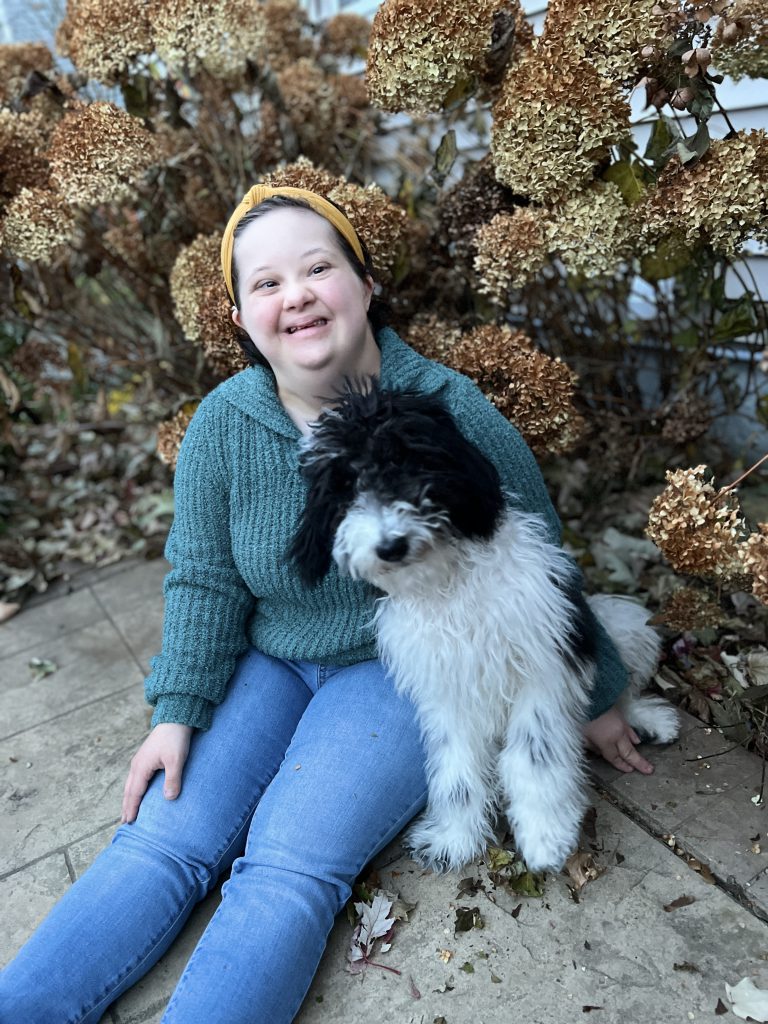 Elly smiling with her dog