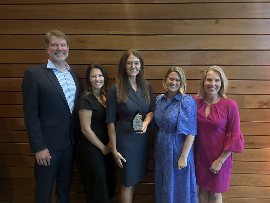 The team of the Minneapolis Emergency Department remodel pose with an award.