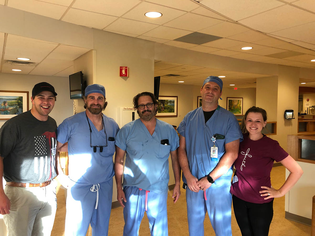 The surgeons with the family after surgery