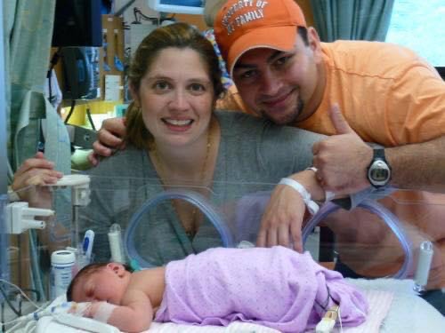 Kaili's parents smile while Kaili is in the NICU at Children's Minnesota