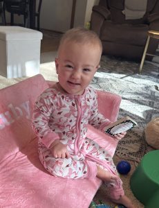 Ruby today at home sitting in a chair, smiling