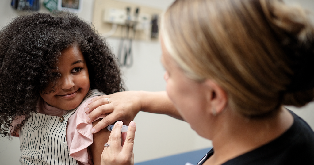 A nurse vaccinates a girl at Children's Minnesota.