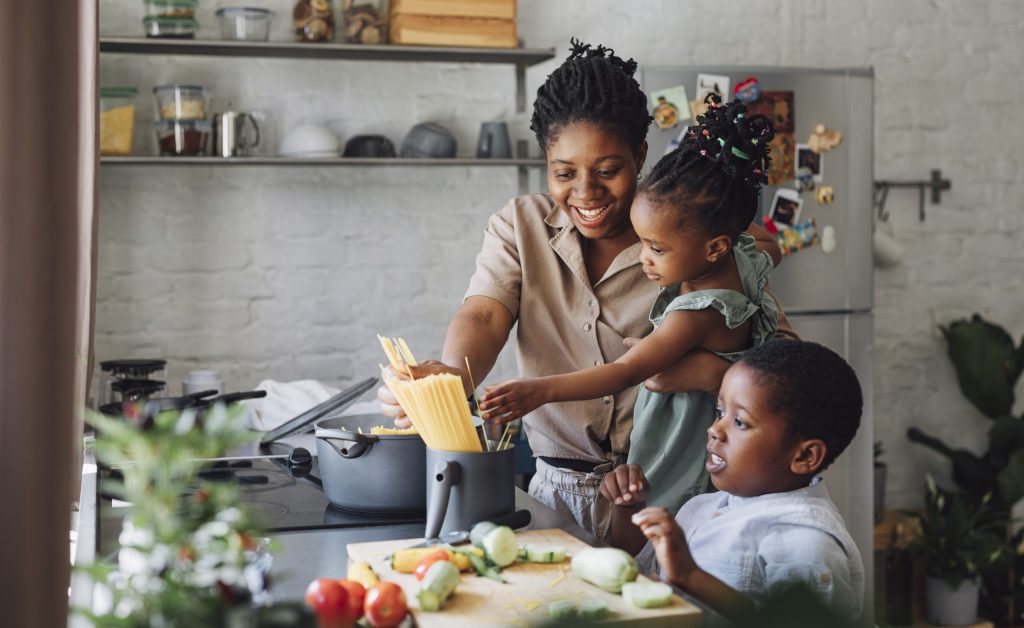 Mom cooking with her two children.