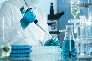 Lab tech putting things in test tubes