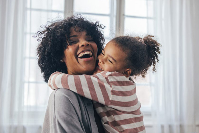 a mom and daughter hug