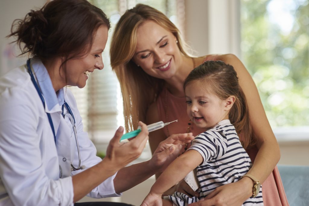 Little girl at the doctors getting a vaccine