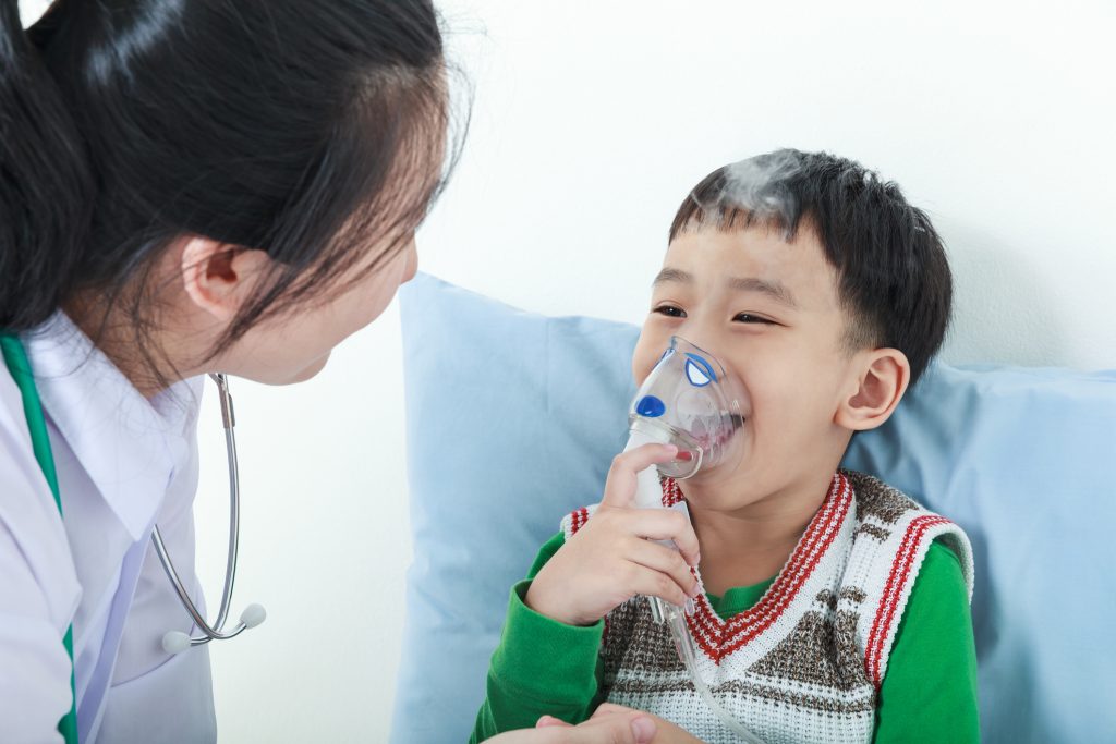 boy using nebulizer