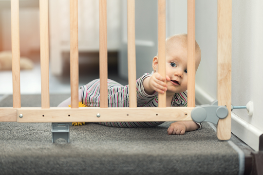 baby near a safety gate