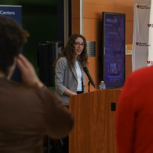 Jennifer Kaluza speaking at a podium.