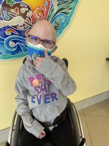 Kali gives a thumbs up after her first COVID-19 vaccine dose