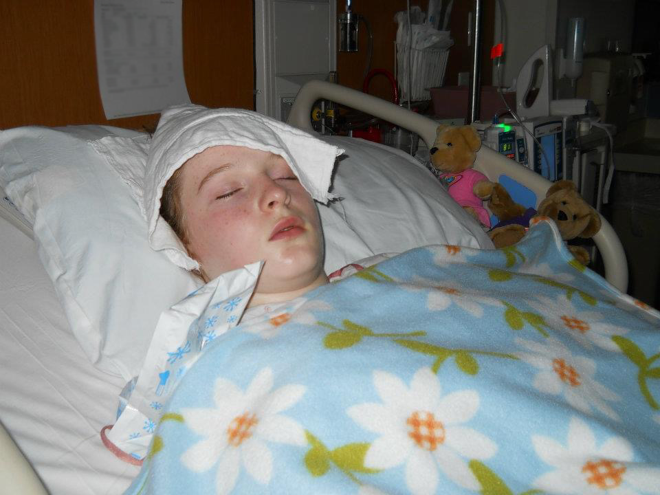 Kali Anderson laying in a hospital bed when she was young