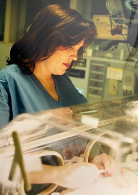 Karen taking care of NICU baby.