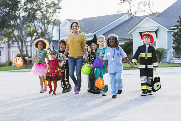Kids trick or treating with an adult