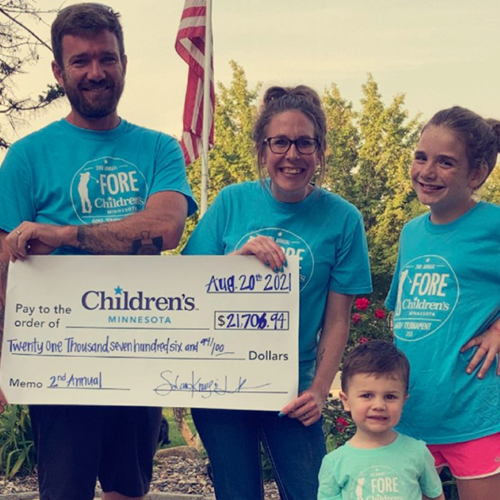 Kraus family holding check Kraus family holding check