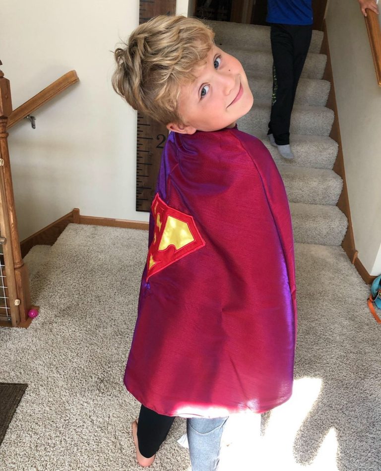 Levi wearing a superman cape.