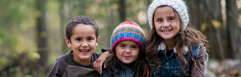 Three siblings with winter hats on