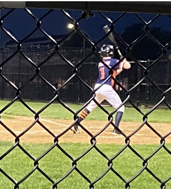 Lincoln playing baseball outside at night