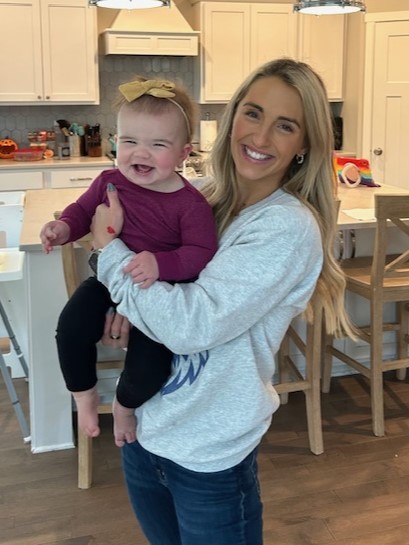 Lucy being held by her mom, Heidi