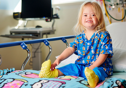 Tullulah sitting on hospital bed smiling