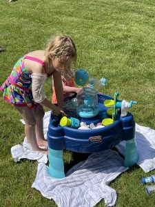 Maddy and Rinken playing with a water table