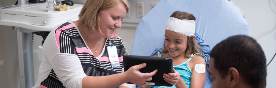 Child Life specialist uses iPad to help distract patient from procedures.