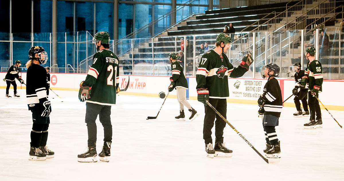 Minnesota Wild players with Children's Minnesota patients on the ice