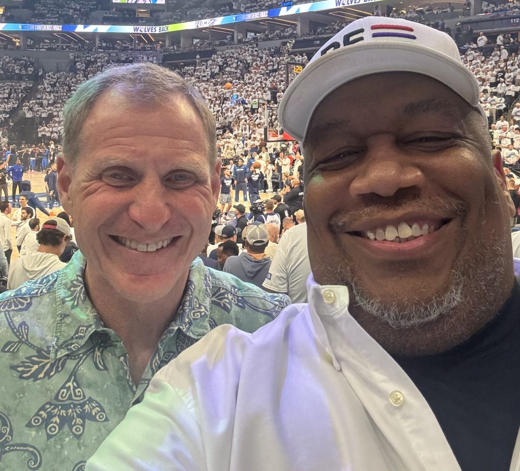 A selfie of Marc Gorelick and James Burroughs at a Timberwolves game.