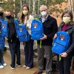 People holding the backpacks