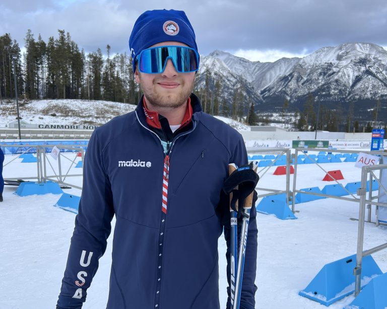 Max wearing his U.S. Paralympic ski uniform and smiling.