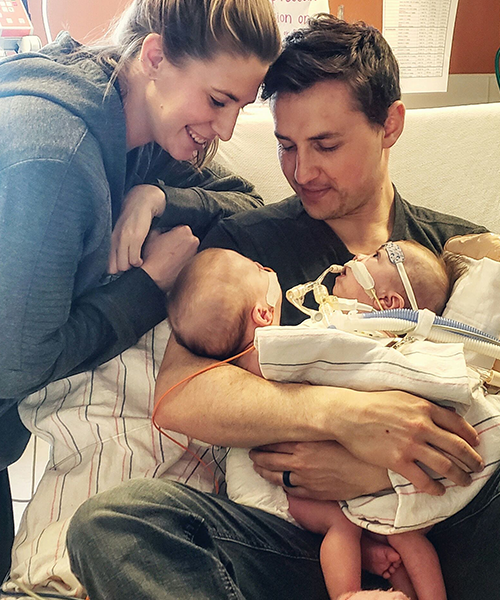 Rob and Kate in the hospital holding their newborn conjoined twins