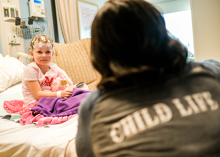 Child in the hospital talking with a child life specialist