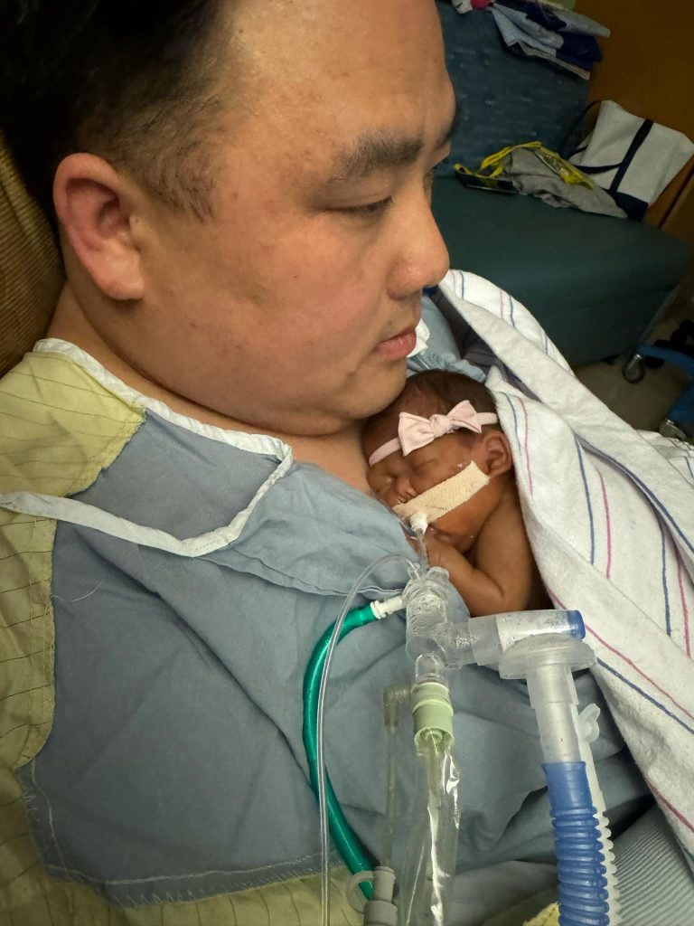 Dad holds baby Gracelyn skin to skin