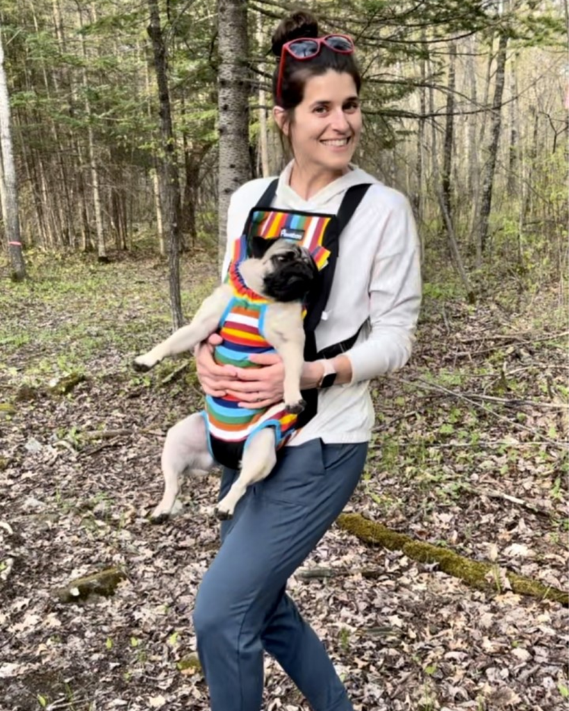 Photo of Mia Guidarelli outside holding her dog